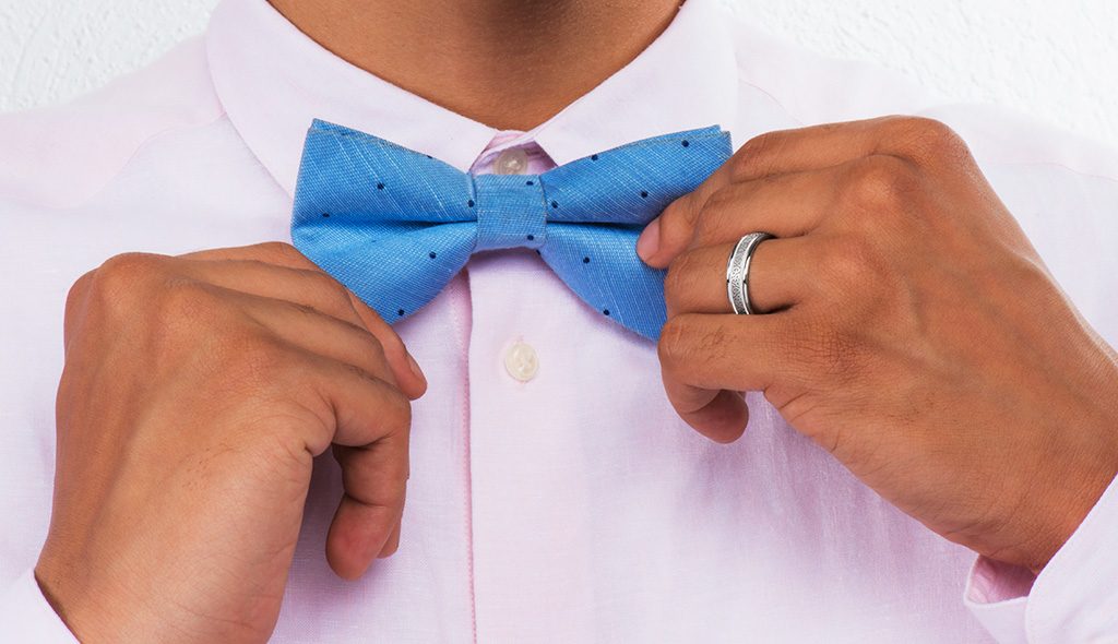 A guy with a bow tie and with a wedding ring for men