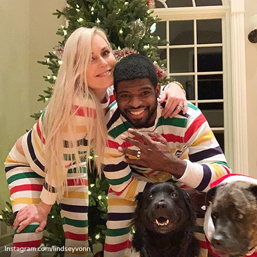 Celebrity engagement rings: Lindsey Vonn and PK Subban wearing pajamas in front of their Christmas Tree as PK displays his gold engagement ring.