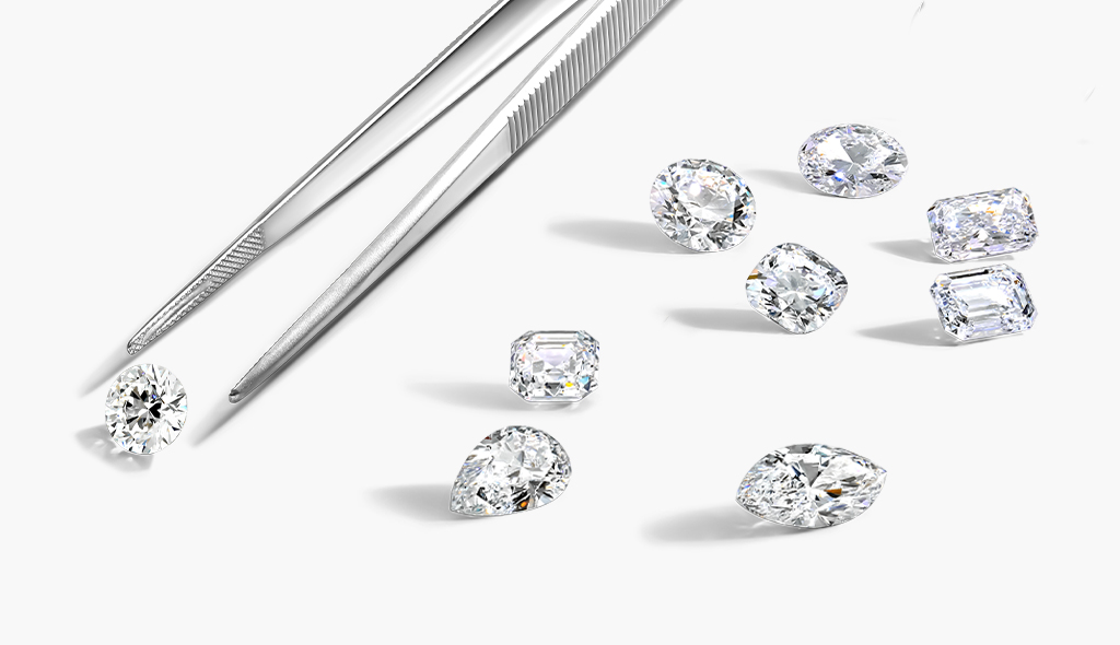 Pair of tweezers and various fancy shaped diamonds 