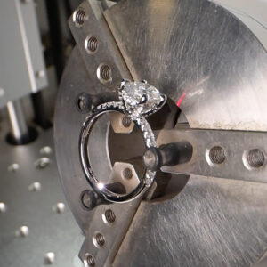 Engraving machine engraving an engagement ring 