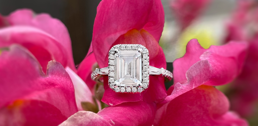 Emerald cut engagement ring with red background