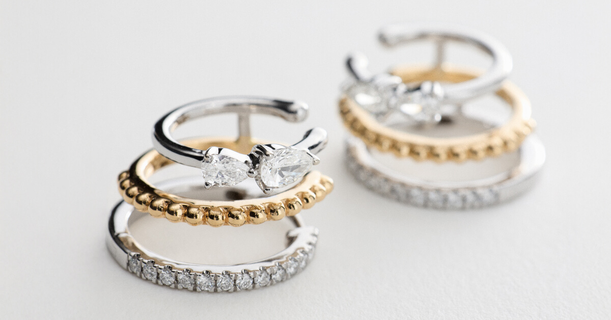 Gold and silver diamond rings stacked