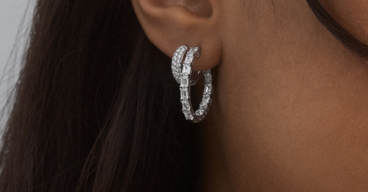 Silver hoop earrings doubled up on a model's ear