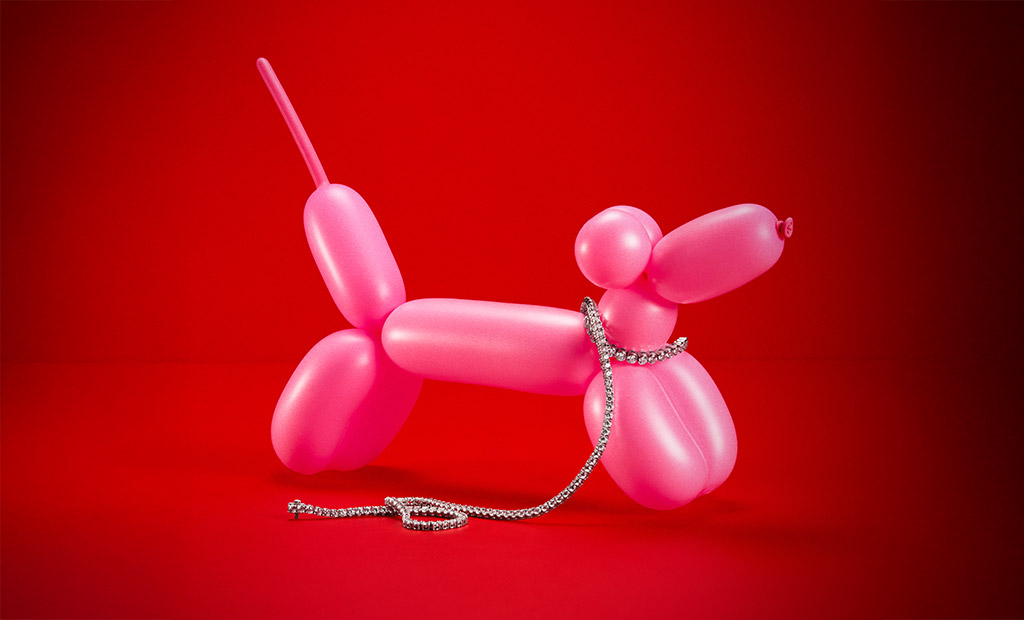 Diamond necklace draped over a pink balloon dog sculpture from James Allen Valentine’s Day collection.
